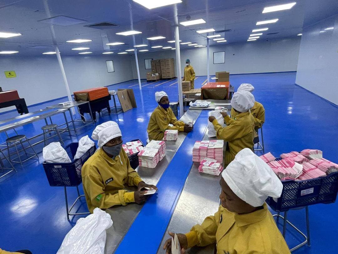 Packaging team inspecting products on the production line
